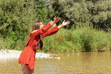 A young woman enjoys her free time at the Isar river in Munich