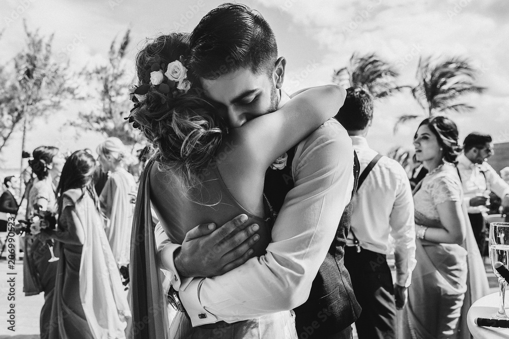 Wall mural indian bride and groom hug each other tender after the wedding ceremony