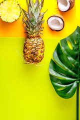 summer dessert with pineapples and coconut on yellow background 
