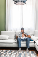 Father and Baby Looking at Tablet