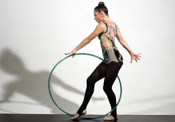 Full Length of Young Pretty Girl Playing Hoola Hoop on White Background.