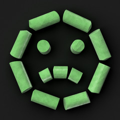 Green sidewalk or blackboard chalks assembled like sad face emoticon on rough blackboard, 3D rendered