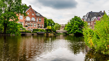 Fototapeta na wymiar old mansion with little bridge, amsterdam on a river