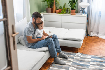 Fototapeta premium Father and Baby Looking at Tablet