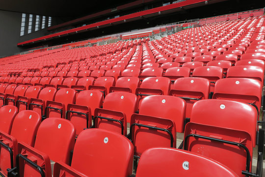 Red chair rows in football stadium.