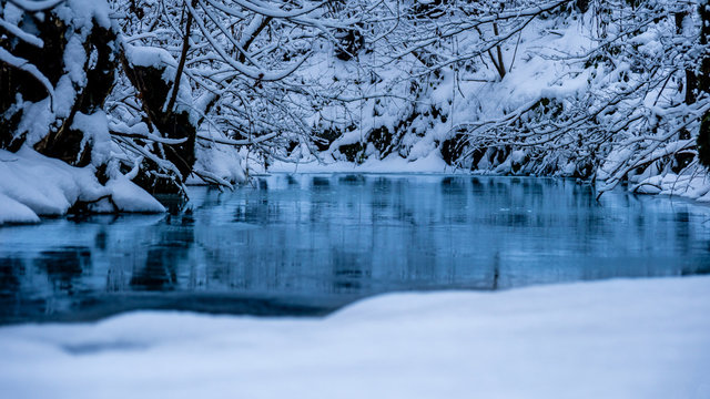 frozen stream really blue water snow