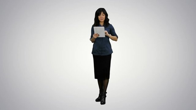 Asian woman look to camera, talking and holding digital tablet on white background