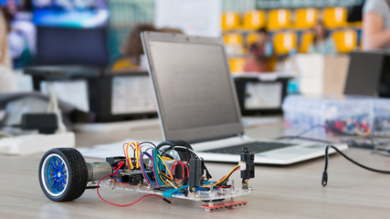A metal car robot and an electronic board that can be programmed. Robotics and electronics....