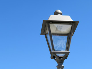 LED street lamp post isolated on blue sky background. Vintage LED lantern