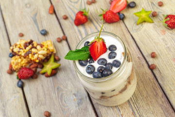 Granola, yogurt and strawberries in a jars