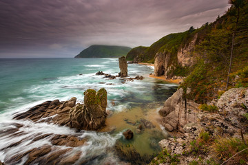 Obraz premium Amazing seascape photo of a beautiful bay with rocks and clouds