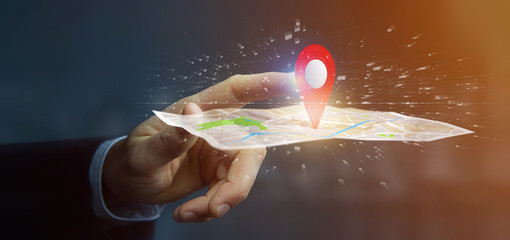 Businessman holding a 3d rendering pin holder on a map