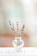 Beautiful composition with lavender flowers in glass bowl standing on a wooden table
