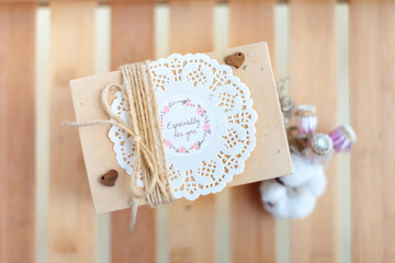 A present box with sign: "Especially for you" on a wooden background