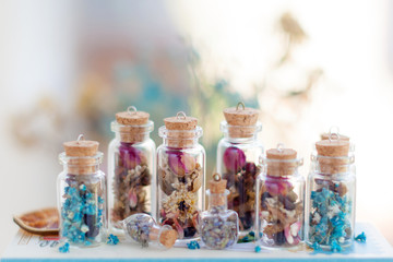 A group of clear glass tubes with aroma flowers contents in miniature