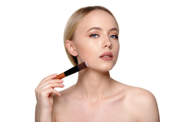 Fototapeta premium Beauty portrait of a smiling beautiful half naked woman posing with make-up brushes
