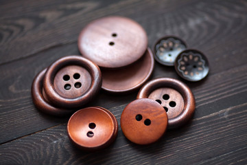 A group of wooden clothes buttons on a dark background
