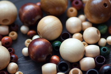 A group of colorful wooden beads on a dark background