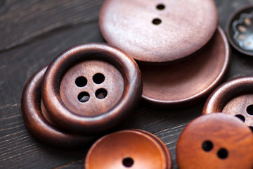 A group of wooden clothes buttons on a dark background