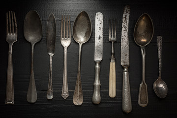 Old Rustic Cutlery on Dark Wooden Background. Kitchen and Food Concept.