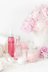 Obraz na płótnie Canvas bath and spa with peony flowers beauty products towels