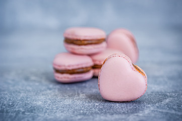 Pink hearts on blue texture background. Greeting card. Heart shaped macarons.  Valentines day concept. Soft focus. Copy space.