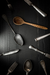 Old Rustic Cutlery on Dark Wooden Background. Kitchen and Food Concept.
