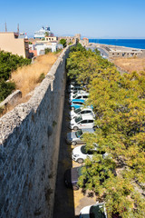 Fototapeta na wymiar View of parking lot next to city walls in City of Rhodes (Rhodes, Greece)