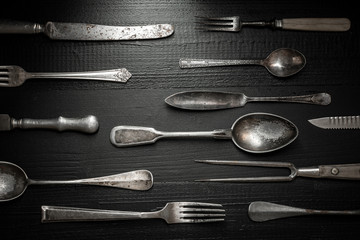 Old Rustic Cutlery on Dark Wooden Background. Kitchen and Food Concept.