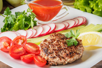 Chopped steak cutlet cooked on grill on white plate