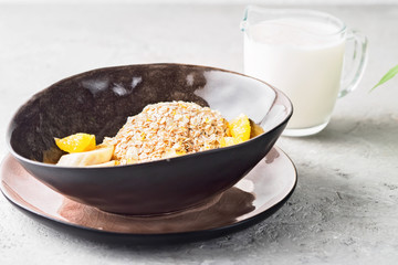 Oats Barley Wheat Rye Corn mix flake proper nutrition diet with pieces banana orange and glass of milk