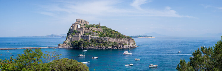Fototapeta na wymiar Ancient castle on the island in the blue sea panorama Ischia