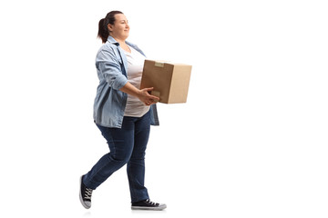 Young woman holding a box and walking