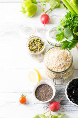 Bowl of assorted fresh colorful seasonal spring summer organic close up vegetables on white wooden shabby table background, healthy food clean eating concept, copy space