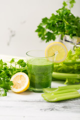 Green cocktail smoothie parsley celery lemon lime slices, healthy drink ingredients, glass of...