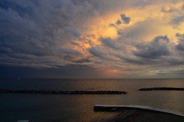 Sunset on the Mediterranean sea from the viewpoint of italy, with cloudy sky