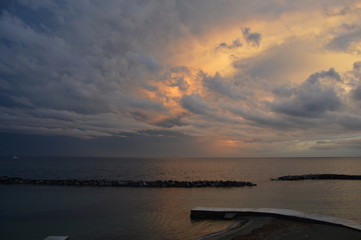 Sunset on the Mediterranean sea from the viewpoint of italy, with cloudy sky