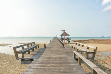 Obraz premium Long wooden bridge go to pavilion on the sea in beautiful tropical island, Thailand.