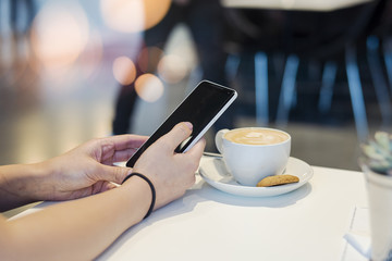Young girl holding mobile phone and unlocking it