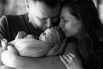 The mother and father embracing   their daughter