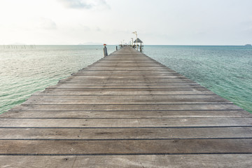 Long wooden bridge go to pavilion on the sea in beautiful tropical island, Thailand.