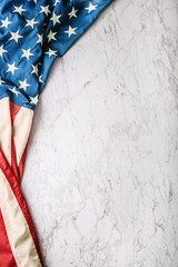 Fototapeta premium Close-up american flag on white marble background