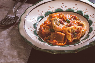 Fresh Homemade Tortellini with Tomato Sauce and Mozzarella Cheese on Rustic Plate