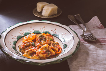 Fresh Homemade Tortellini with Tomato Sauce and Mozzarella Cheese on Rustic Plate