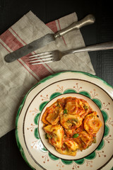 Fresh Homemade Tortellini with Tomato Sauce and Mozzarella Cheese on Rustic Plate