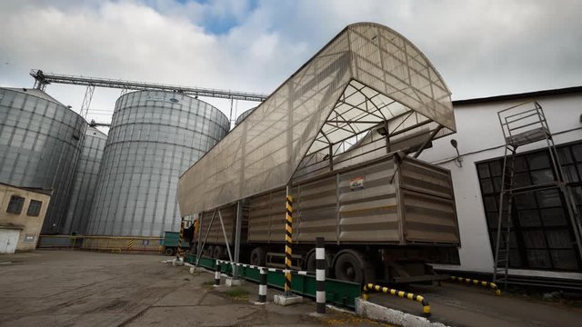 Timelapse of probe tester plunges into the truck trailer to collect wheat for quality analysis. Automatic control system, testing machine at mill, bakery, bread factory or grain elevator terminal.