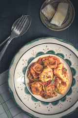 Fresh Homemade Tortellini with Tomato Sauce and Mozzarella Cheese on Rustic Plate