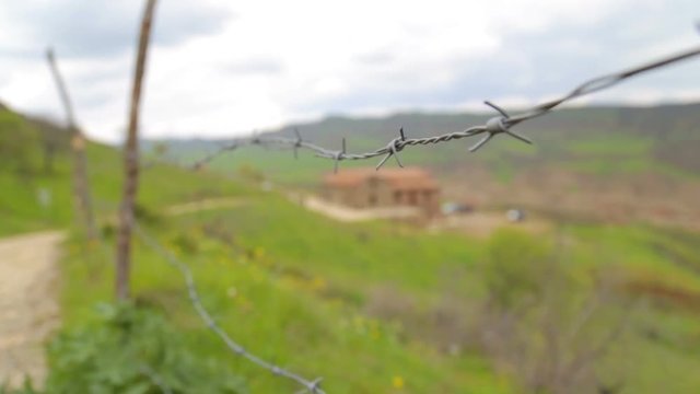 Fence with barbed wire