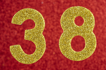 Number thirty-eight gold color over a red background. Anniversary