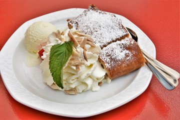 piece of cake, whipped cream and a ball of ice cream